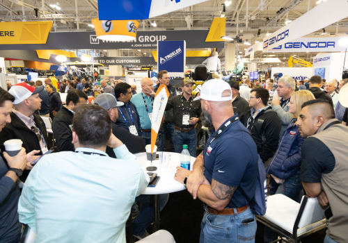 World of Asphalt show floor attendees around a table discussiong 
