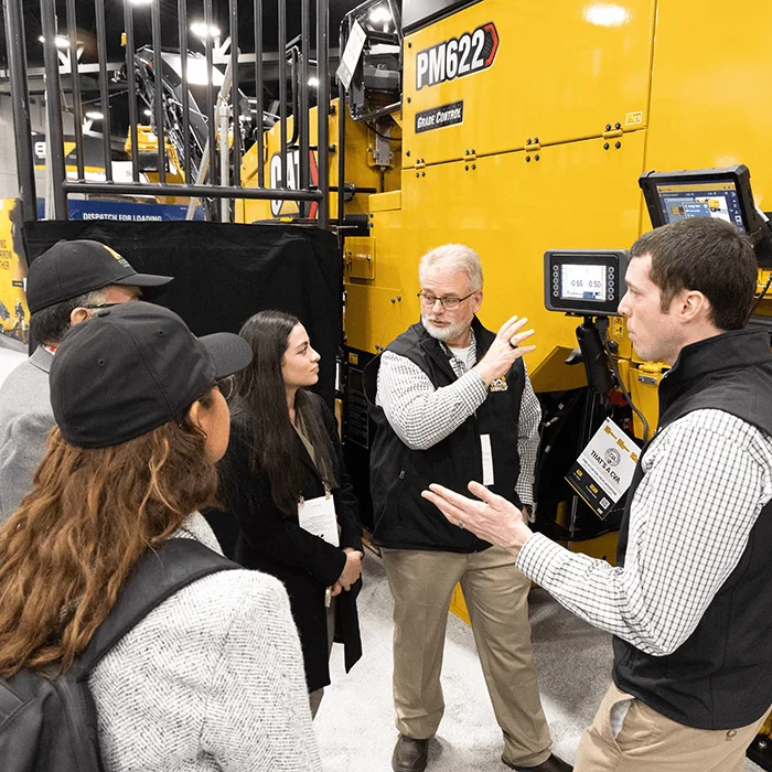 Two guys talking about equipment at World of Asphalt