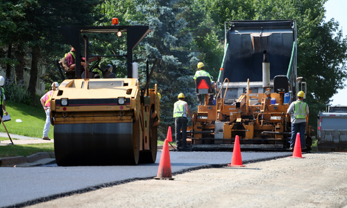 Asphalt Team paving a road.
